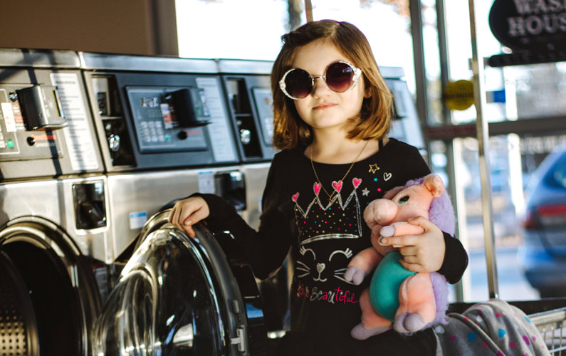 Young customer in laundromat